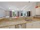 Modern kitchen with stone countertops, a stainless steel sink, and views into an open floorplan at 3405 54Th W Dr # 102, Bradenton, FL 34210