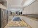 Kitchen island with cooktop, stainless steel appliances and granite countertops with eat-in bar at 3405 54Th W Dr # 102, Bradenton, FL 34210