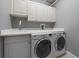 A utility room with a front load washer and dryer plus lots of cabinet space at 3405 54Th W Dr # 102, Bradenton, FL 34210