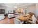 Open-concept living room showcases a hardwood floor, dining table, and elegant decor at 3405 54Th W Dr # 102, Bradenton, FL 34210