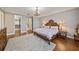 Spacious primary bedroom with hardwood floors, a chandelier, and en-suite bathroom access at 3405 54Th W Dr # 102, Bradenton, FL 34210