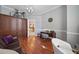 Bright home office features wood floors, a desk with a chair, and a large storage cabinet at 3405 54Th W Dr # 102, Bradenton, FL 34210
