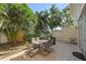 A tiled patio area is furnished with an outdoor dining table, chairs, and a grill at 3405 54Th W Dr # 102, Bradenton, FL 34210