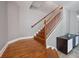 A staircase with hardwood floors and white painted spindles leads to the next level at 3405 54Th W Dr # 102, Bradenton, FL 34210