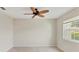 This bedroom is a blank slate ready for your personal touch, featuring a ceiling fan and window at 3449 Yonge Ave, Sarasota, FL 34235