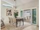 Bright dining room with a chandelier, adjacent to an outdoor patio through glass sliding doors at 3449 Yonge Ave, Sarasota, FL 34235