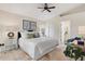 Bright main bedroom features neutral paint, ceiling fan, ensuite bathroom access and comfortable bed at 3449 Yonge Ave, Sarasota, FL 34235