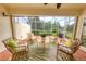 This screened patio overlooks the pond and has comfortable outdoor seating, perfect for relaxing at 3449 Yonge Ave, Sarasota, FL 34235