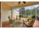 Screened patio provides an excellent view of a serene pond, with comfortable seating for entertaining at 3449 Yonge Ave, Sarasota, FL 34235