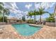 Enjoy the community pool with chairs and tables perfect for relaxation under sunny skies at 3449 Yonge Ave, Sarasota, FL 34235