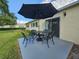 Inviting outdoor patio with a stylish table and chairs, perfect for relaxation at 390 301 W Blvd # 5B, Bradenton, FL 34205
