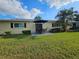 Expansive backyard featuring a patio with outdoor furniture and a well-maintained lawn at 390 301 W Blvd # 5B, Bradenton, FL 34205
