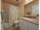 Well-lit bathroom featuring a tub with shower and a modern vanity with light countertop at 390 301 W Blvd # 5B, Bradenton, FL 34205