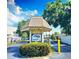 Community entrance featuring a welcoming sign, gated access, and lush greenery at 390 301 W Blvd # 5B, Bradenton, FL 34205