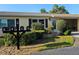 Charming villa exterior with manicured landscaping, multiple mailboxes, and well-maintained facade at 390 301 W Blvd # 5B, Bradenton, FL 34205