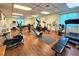 Well-equipped gym featuring treadmills, elliptical machines, weights, and mirrors for a complete workout experience at 390 301 W Blvd # 5B, Bradenton, FL 34205