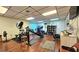 Well-equipped gym featuring treadmills, elliptical machines, weights, and mirrors for a complete workout experience at 390 301 W Blvd # 5B, Bradenton, FL 34205