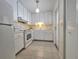 Bright kitchen with white cabinetry, appliances, and a view to the backyard at 390 301 W Blvd # 5B, Bradenton, FL 34205