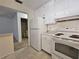Functional kitchen with white appliances and neutral countertop at 390 301 W Blvd # 5B, Bradenton, FL 34205