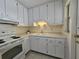 Classic kitchen with white cabinets and appliances, and ample counter space at 390 301 W Blvd # 5B, Bradenton, FL 34205