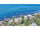 Aerial view of a waterfront property featuring a pool, lush landscaping, and proximity to the water and waterfront neighborhood at 3931 Bay Shore Rd, Sarasota, FL 34234
