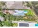 Aerial view of the home showcasing the roofline, pool, backyard, landscaping, and proximity to the water at 3931 Bay Shore Rd, Sarasota, FL 34234