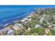Aerial view of waterfront homes showcasing coastal living, lush landscaping, and stunning water views at 3931 Bay Shore Rd, Sarasota, FL 34234