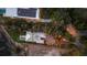 Aerial view of waterfront properties featuring lush landscaping, and neighborhood streetlights, creating an inviting ambiance at 3931 Bay Shore Rd, Sarasota, FL 34234