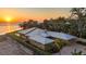 Coastal home with a metal roof, pool, and a brick driveway, offering luxury and style at 3931 Bay Shore Rd, Sarasota, FL 34234