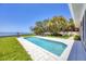 A well-maintained backyard and swimming pool sit between the house and ocean at 3931 Bay Shore Rd, Sarasota, FL 34234