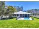 A serene backyard with lounge chairs by the pool and lush green grass at 3931 Bay Shore Rd, Sarasota, FL 34234