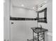 Modern bathroom with a black granite vanity, glass shower, and sleek finishes at 3931 Bay Shore Rd, Sarasota, FL 34234