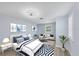 Bright bedroom boasts a stylish sitting area, modern ceiling fan and chic decor at 3931 Bay Shore Rd, Sarasota, FL 34234