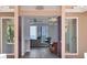 Inviting entryway with view of the waterfront living area with abundant natural light and chandelier at 3931 Bay Shore Rd, Sarasota, FL 34234
