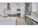 Modern kitchen featuring white countertops, stainless steel appliances, and ample cabinet space at 3931 Bay Shore Rd, Sarasota, FL 34234