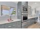 Modern kitchen featuring stainless steel appliances, custom cabinets, and waterfront view at 3931 Bay Shore Rd, Sarasota, FL 34234