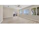 Spacious living room with beautiful floors, ceiling fan, and sliding doors leading to outdoor patio at 3931 Bay Shore Rd, Sarasota, FL 34234