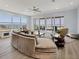 Bright living room with water views, contemporary furnishings, and sliding glass doors to the outdoor patio at 3931 Bay Shore Rd, Sarasota, FL 34234