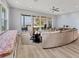 Bright living room featuring a window seat and sliding glass doors to the patio, offering stunning waterfront views at 3931 Bay Shore Rd, Sarasota, FL 34234
