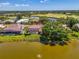 Aerial view showing a charming house backyard, pool, and serene water view, encircled for clarity at 407 Fieldstone Dr, Venice, FL 34292
