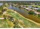 Expansive aerial view of a golf course and waterfront homes, showcasing a luxurious and serene community layout at 407 Fieldstone Dr, Venice, FL 34292