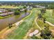 Scenic aerial view of the community, golf course, and the waterfront homes creating a desirable living environment at 407 Fieldstone Dr, Venice, FL 34292