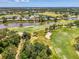 Stunning aerial view highlighting the home's location, situated between the golf course and the water at 407 Fieldstone Dr, Venice, FL 34292