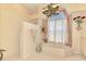Bright bathroom featuring a tub, shower, and a unique window design with decorative accents at 407 Fieldstone Dr, Venice, FL 34292