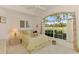 Cozy bedroom with a large window, scenic views, and a comfortable bed setting at 407 Fieldstone Dr, Venice, FL 34292