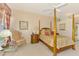 Bedroom features a four-poster bed, ceiling fan, and sitting area at 407 Fieldstone Dr, Venice, FL 34292
