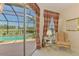 Bedroom view overlooking golf course, pool, and patio via sliding glass doors at 407 Fieldstone Dr, Venice, FL 34292