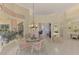 Open-concept breakfast nook with glass table, chandelier, and access to the lanai at 407 Fieldstone Dr, Venice, FL 34292