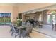 Elegant dining area transitioning to a living space with a grand piano and stylish decor at 407 Fieldstone Dr, Venice, FL 34292
