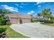 Charming residence with a two-car garage, brick paved driveway, and well manicured lawn at 407 Fieldstone Dr, Venice, FL 34292